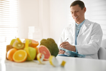 Fototapeta premium Nutritionist working at desk in his office
