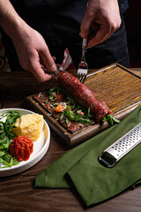 Beef carpaccio with capers on dark background, selective focus