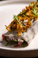 warm beef carpaccio with rosemary and red wine