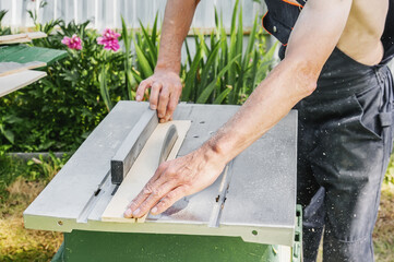 turner works on a lathe. saw table. a man steals a tree with a milling machine. experienced carpenter cuts a wooden board with a circular saw.