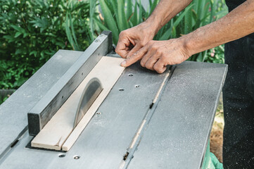 turner works on a lathe. The saw table. a man steals a tree with a milling machine. An experienced...