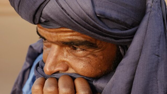 Closeup portrait of a Moroccan man wearing a turban. Authentic Bedouin of South Morocco. 4k.
