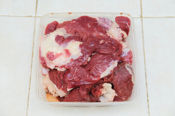 Top view of fresh raw beef meat inside plastic container