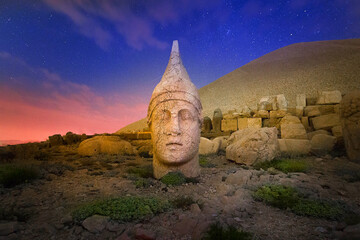 East terrace of Mount Nemrut at sunrise with Great alter in front of statues and the tumulus. The...