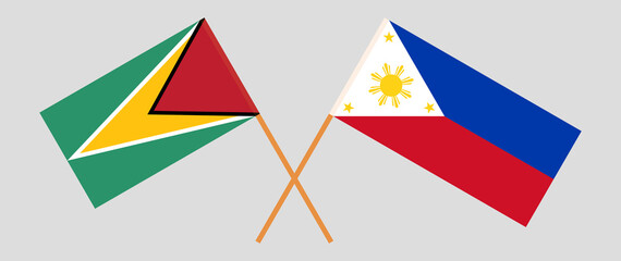 Crossed flags of Guyana and the Philippines. Official colors. Correct proportion