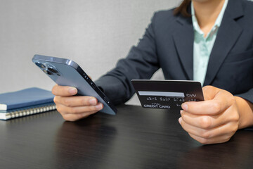 Businessman keying credit card information into mobile  concept finance, banking, online shopping.