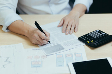 A close-up photo of a businessman's hand working on paperwork, an accountant, a financier,...