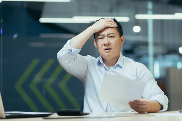 Disappointed businessman received negative message letter from bank, holding his head in horror,...