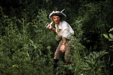 Sea robber ship captain armed pirate goes through jungle. Concept historical halloween. Filibuster cosplay