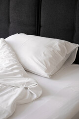 white pillow and blanket on the bed top view. bedding in a hotel room