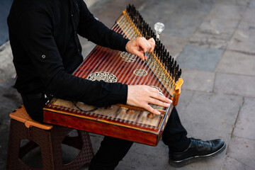 The man playing the Turkish instrument qanun in the street