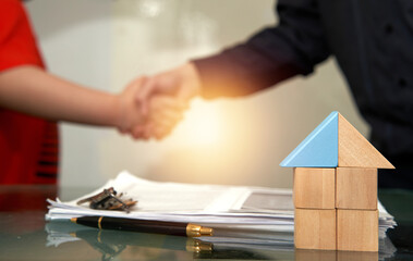 house agent shaking hand with customer for rent or buy home from agency