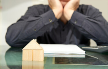 man sad with house loan bankruptcy