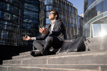 A man meditates balance and harmony calming down after working in the office