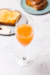 glass of orange juice and brioche