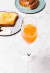 glass of orange juice and brioche