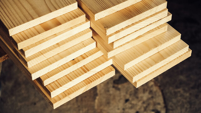 Stacked wooden carpentry boards from natural wood in a woodworking industry