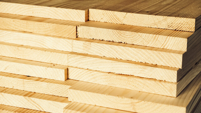 Stacked wooden carpentry boards from natural wood in a woodworking industry
