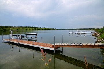 boat docks and lifts along the shoreline of a lake