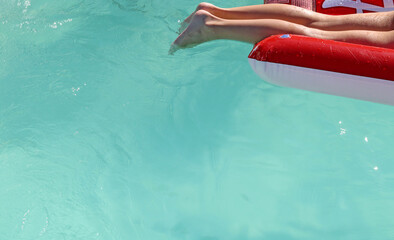 Boy or girl on an inflatable or Floating Sleeping Bed in a swimming pool 