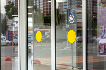 Supermarket automatic glass doors with camera sign closeup