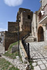 A narrow street between the old houses of Grottole, a village in the Basilicata region, Italy.
