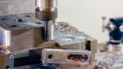 Close-up of metal drilling machine polishing metal thing. Stainless drill and shavings from...