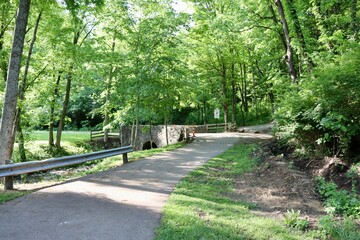 The old stone bridge on the pathway in the park.