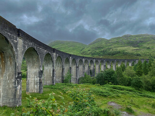 Fototapeta na wymiar old historic Glenfinnan Viaduct bridge with landscape in Scotland