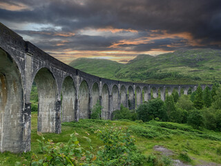 Fototapeta na wymiar old historic Glenfinnan Viaduct bridge with landscape in Scotland