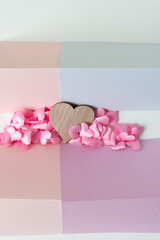 blank pastel paper cards, wooden heart shape, and fabric pink pillow hearts
