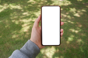 Mockup picture of business woman’s hands holding smart phone with white blank screen in modern place
