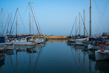 Naklejka na ściany i meble early morning in the port. with very calm sea and yachts