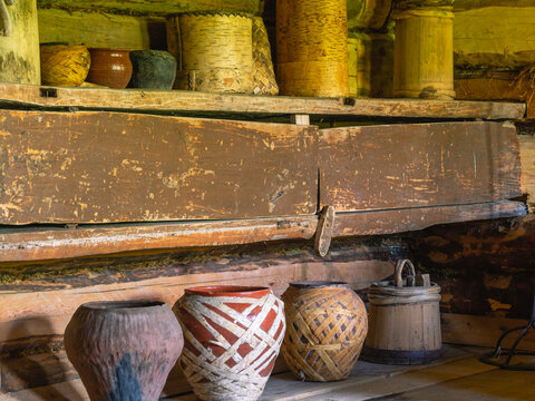Antique tableware made in the 19th century. Historical interior in an old wooden house in the countryside. Household items and furniture in an old 19th century house.