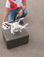 A surveyor setting up a drone to conduct topographic RTK or PPK aerial survey or photography of a...