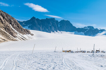 A view past kennels in a musher camp on the Denver glacier close to Skagway, Alaska in summertime