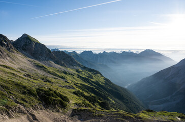 Golden hour with a piece of fog in the Alps