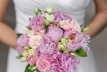 Bridal bouquet of pink peonies with roses