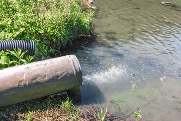 Domestic waste water flows down the sewer drainage pipe into the river. Environmental pollution