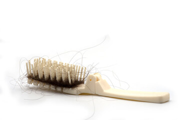 White comb with hair loss, hair fall on white background and copy space.