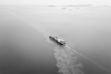 black and white cargo container ship full speed sailing in sea import and export business and industry logistic goods transportation of international by container ship in ocean fright aerial view