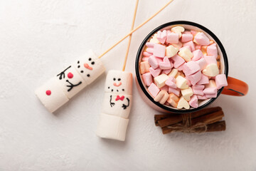 Hot chocolate mug and a snowman made of marshmallows.Cocoa drink.Sweet treat for kids funny marshmallow snowman. Christmas winter holiday decoration. New Year card.Winter hot drink.