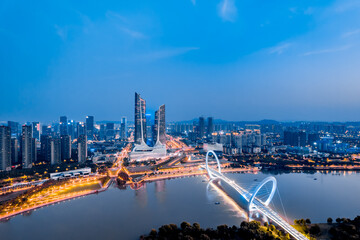 Obraz premium Night view of city skyline of Nanjing Eye Bridge and Poly Theater in Nanjing, Jiangsu, China