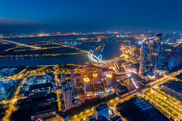 Obraz premium Night view of city skyline of Nanjing Eye Bridge and Poly Theater in Nanjing, Jiangsu, China