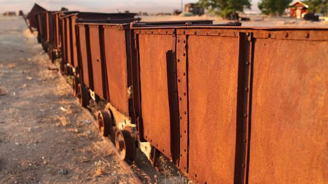 Slider Shot of Old Mining Ore Carts at Sunrise with Shallow Depth of Field.
