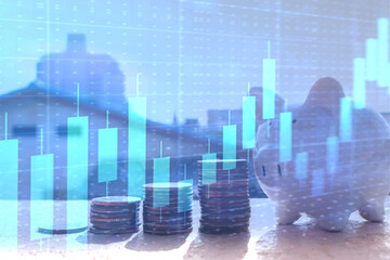 Piggy bank and Money coin stack growing graph with blurred Construction home background, Saving...