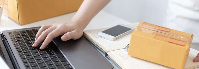 Young woman uses a laptop to chat with customers who come to order product, New young businesses...