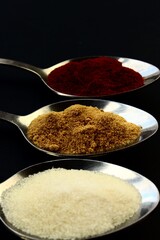 salt and pepper on spoon