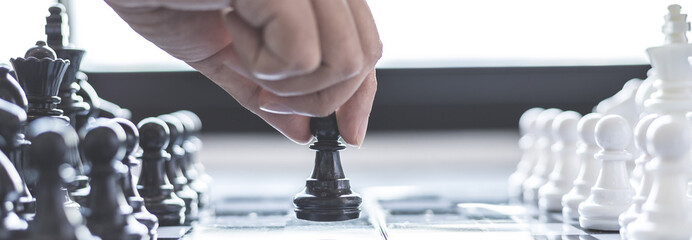 Businesswoman holding chess to take down opposing players, Proactive business planning and...