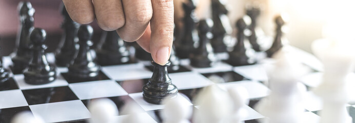 Businesswoman holding chess to take down opposing players, Proactive business planning and...